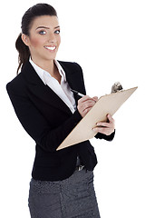 Image showing Business professional writes on pad