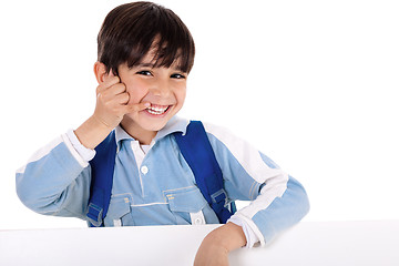 Image showing Smiling young boy acts as he talks over phone