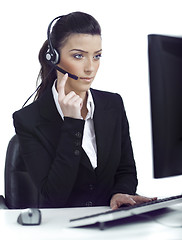 Image showing Busy woman seriously hearing the customer talk in headset