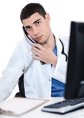 Image showing Male doctor speaking over telephone