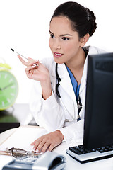 Image showing Thinking doctor with her pen