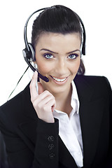 Image showing Call center woman dealing with the customer wearing headset