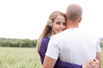 Image showing Beautiful young lady hugging her husband