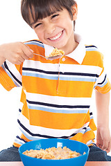 Image showing Young boy eating his breakfast