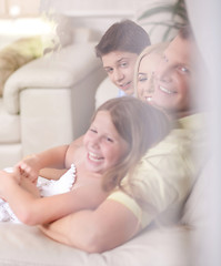 Image showing Happy family smiling and looking  behind the window glass