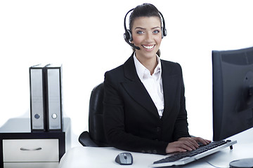 Image showing Pretty business woman working at office wearing headset