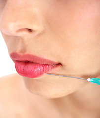 Image showing Doctor giving injection on face of a young woman on her upper lip