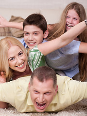 Image showing Happy family Lying On Top Of Each Other