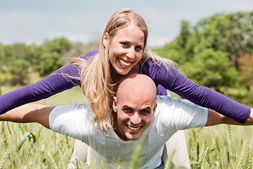 Image showing Young man giving shoulder ride to her girlfriend