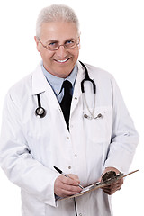 Image showing Portrait of senior doctor writing reports