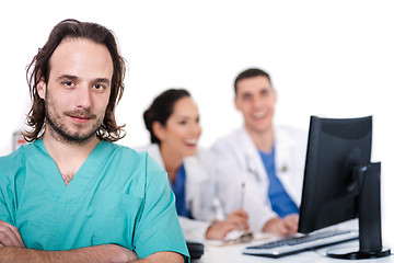 Image showing Male doctor on focus, two doctors discussing at background