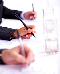 Image showing Business people taking notes in the business conference