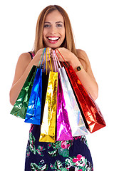 Image showing Happy woman holding lots of shopping bags in her hand