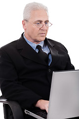 Image showing Mature business man busy working in notebook