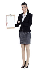 Image showing Full length of business woman pointing at the clipboard