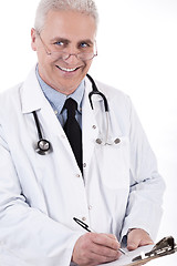 Image showing Smiling medical doctor writing prescription