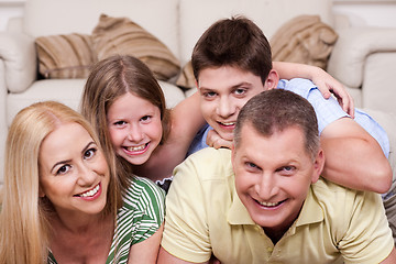 Image showing Smiling family lying together on the floor