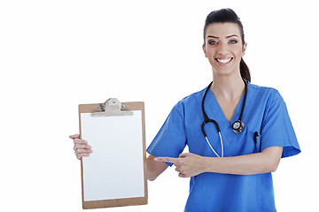 Image showing Portrait of young nurse pointing blank clipboard
