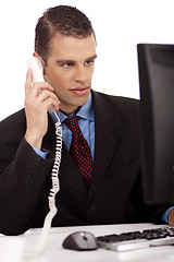 Image showing young profesional business men sitting and talking over phone