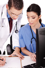 Image showing Young doctors discussing and making notes