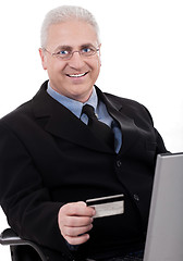 Image showing Senior business man making online purchase with his credit card