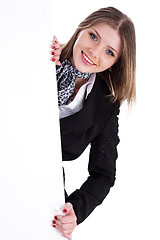 Image showing Happy young women peeking through a blank board