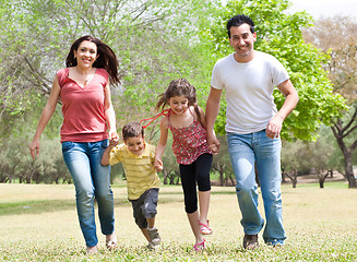 Image showing Family running on green grass field