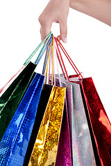 Image showing Colorful shopping bags holding by human hand