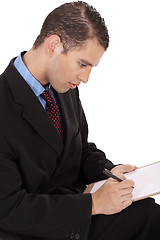 Image showing Closeup of a business man writing down