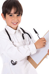 Image showing Little boy doctor writes on his clipboard for diagnosis