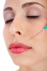 Image showing Close up shor of a  pretty girl getting Botox injection