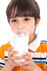 Image showing Happy kid drinking glass of milk