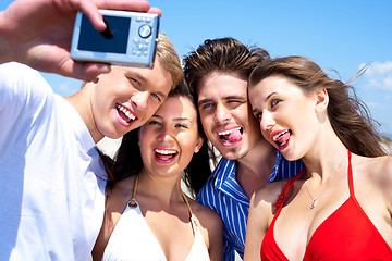 Image showing Group of young friends standing together taking a self portrait