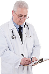 Image showing Portrait of senior doctor writing reports