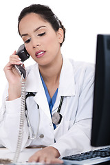 Image showing Asian female doctor talking over phone