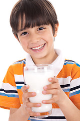 Image showing Happy kid holding a glass of milk
