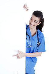 Image showing Portrait of female nurse standing behind the white board