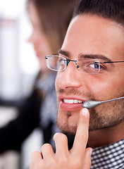 Image showing business man speaking through head phone