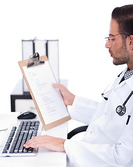 Image showing busy doctor working with his reports