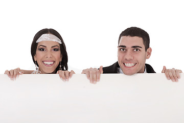 Image showing Newly married couple standing behind the board