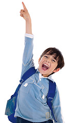 Image showing Young school boy excitingly shouts and raise his hand up