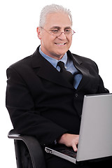 Image showing Mature business man in working with laptop