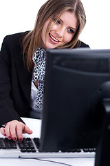 Image showing Smiling professional working with desktop at his desk