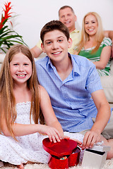 Image showing Happy young kids with gift boxes in living room