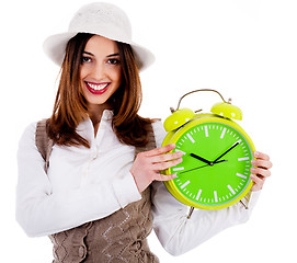 Image showing stylish lady holding alarm clock