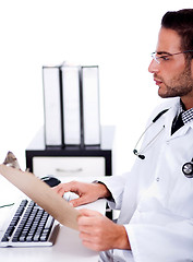 Image showing busy doctor working with his reports
