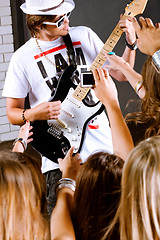 Image showing Guitarist performing for his adoring fans