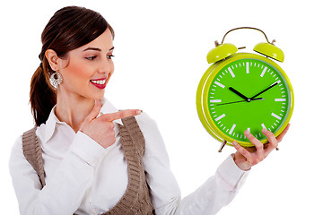 Image showing lady pointing at alarm clock
