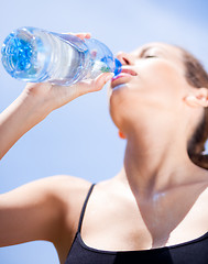 Image showing Fitness woman drinking water