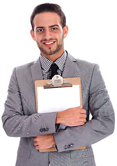 Image showing Young business man holding a clip board